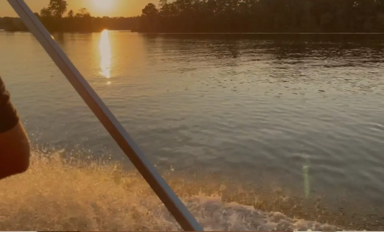 Boat on river at sunset, scenic view.