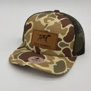Camouflage cap with dog logo patch.